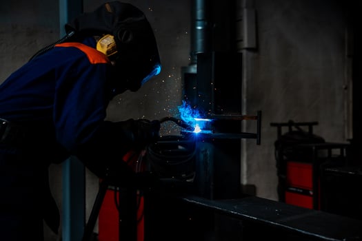 welder and welding sparks, construction and metal work industrial concept, metal welding with sparks photo