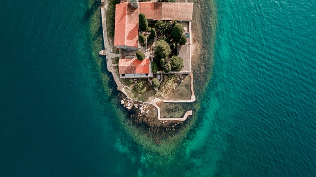 aerial view of a historic island fortress surrounded by turquoise waters under a clear sky photo