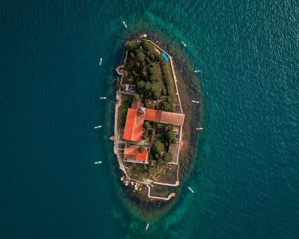 aerial view of a historic island fortress surrounded by turquoise waters under a clear sky photo