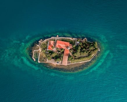 aerial view of a historic island fortress surrounded by turquoise waters under a clear sky photo