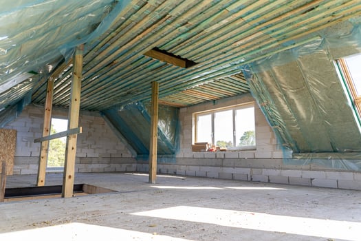Spacious attic under construction with thermal insulation and skylights in a new home photo