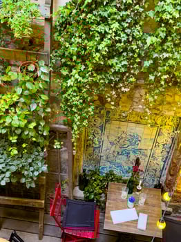 Charming Cafe Corner with Ivy and Decorative Wall Tiles photo