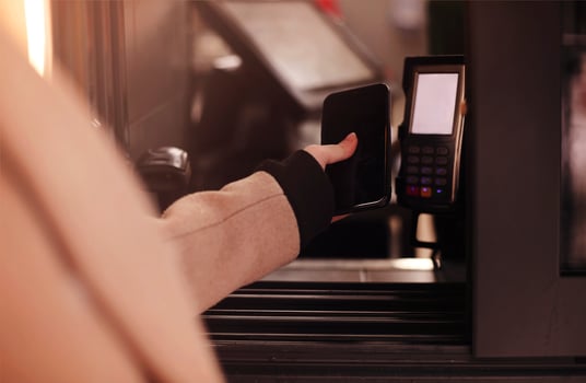 Crop woman paying for service with smartphone photo