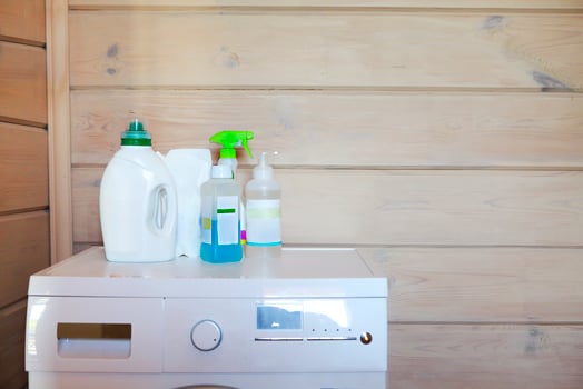 Plastic cleaning supplies on washing machine photo