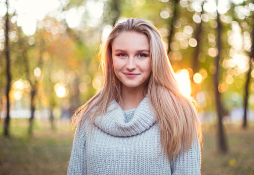 Happy blond girl posing in autumn park photo
