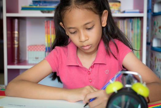 Little girl drawing and writing on desk at home, Education concept. photo
