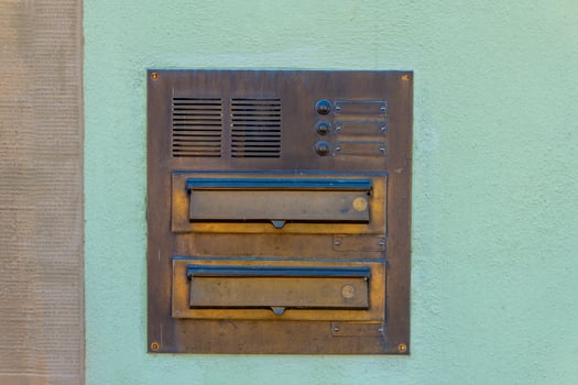 old mailbox with two compartments on a wall photo