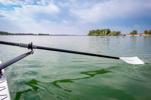 hatchet sculling oar and a rowing shell on a calm lake in summer, Boyd Lake in Colorado photo