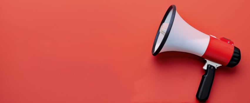 Megaphone Positioned on Red Background for Announcements and Communication photo