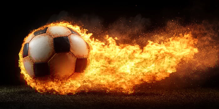 A soccer ball bursting through flames creates an intense athletic atmosphere photo