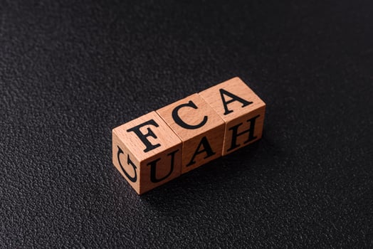 Inscription FCA wooden cubes, conceptual background with copy space photo