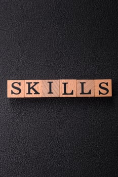 The inscription Skills made of wooden cubes on a plain background photo
