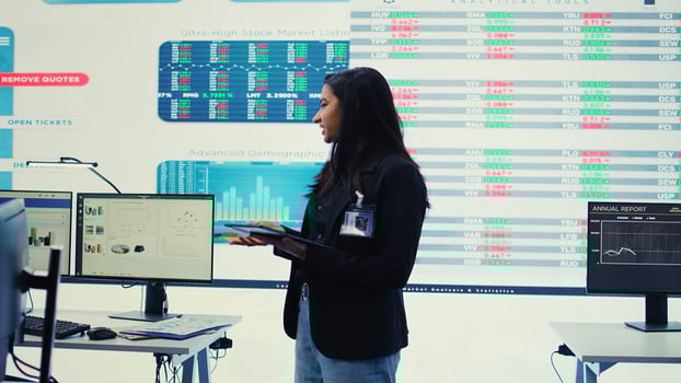 Enterprise manager looking into project updates and details in monitoring room, establishing resource allocation plans to achieve strategic business goals. Corporation operations. Camera B. photo