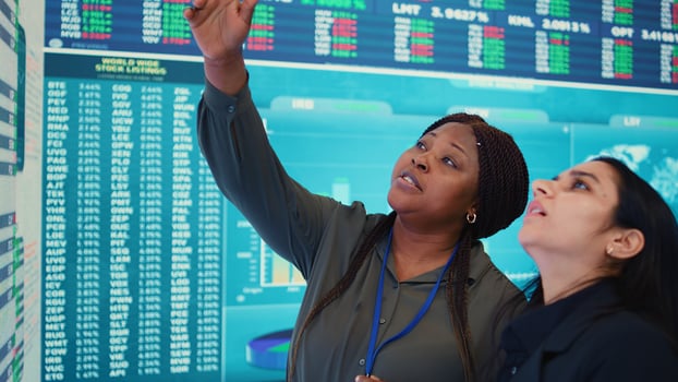 Enterprise colleagues reviewing efficiency and performance metrics within the organization, giving project insight. Partners evaluating statistics and data reports on a big screen. Camera B. photo