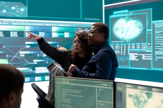 Governmental hackers analyzing cyber threats on big screens, managing important database hacking activity in high tech agency office. Work on cyber defense to protect national security. photo