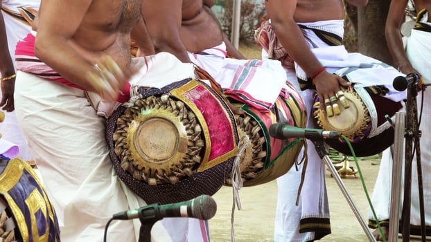 An artists playing Maddalam, a South Indian traditional musical instrument photo