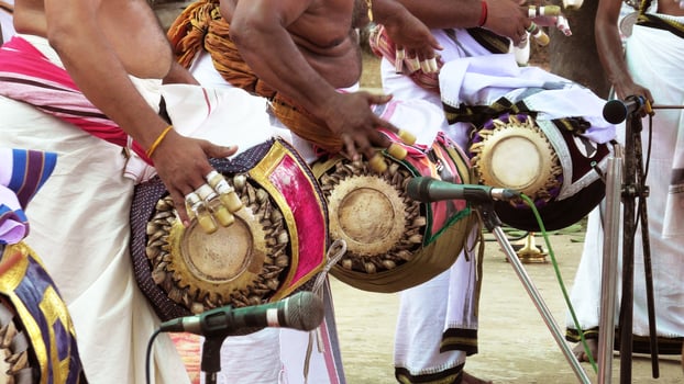 An artists playing Maddalam, a South Indian traditional musical instrument photo