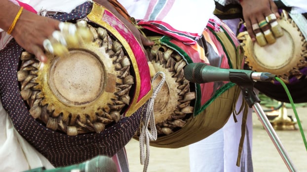 An artists playing Maddalam, a South Indian traditional musical instrument photo