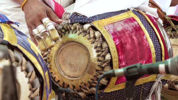An artists playing Maddalam, a South Indian traditional musical instrument photo