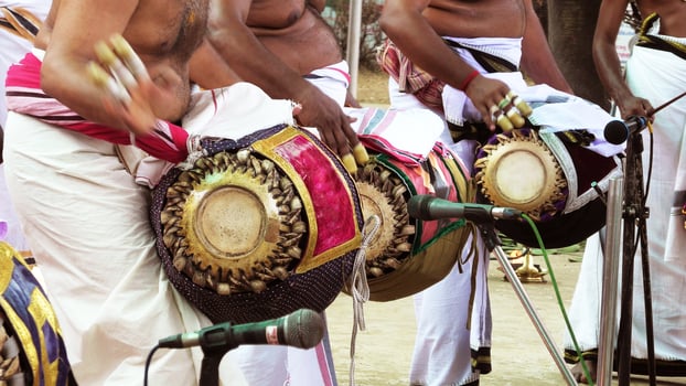 An artists playing Maddalam, a South Indian traditional musical instrument photo