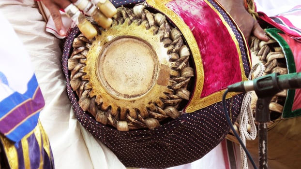 An artists playing Maddalam, a South Indian traditional musical instrument photo