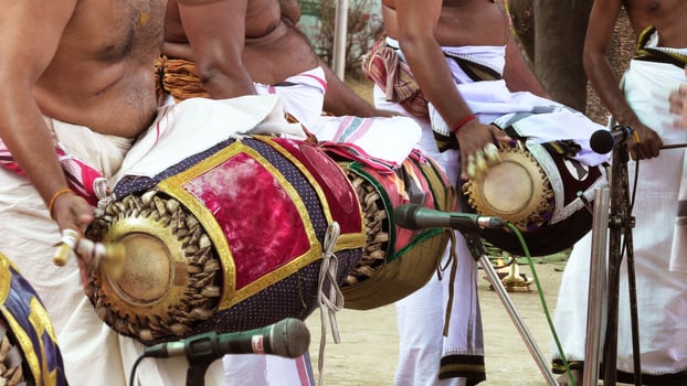 An artists playing Maddalam, a South Indian traditional musical instrument photo