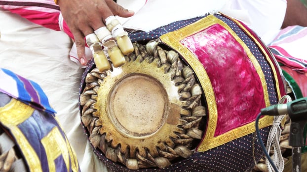 An artists playing Maddalam, a South Indian traditional musical instrument photo