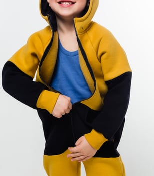 Child in Yellow and Black Hoodie Smiling photo