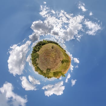 simple little tiny planet without buildings in blue sky with beautiful clouds. Transformation of spherical panorama 360 degrees. Spherical abstract aerial view. Curvature of space. photo