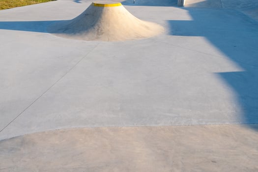 view of a ramp at a skatepark at sunset photo