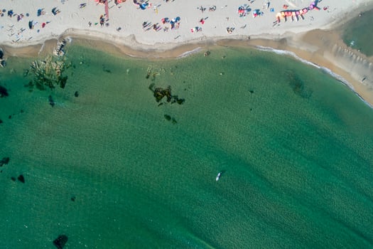 drone aerial view of the shore of a popular beach in the summertime, holidays concept photo