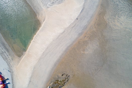 zenithal top aerial view of a beach with footprints of people in the sand photo