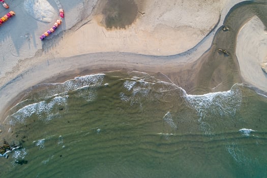 Aerial view of colorful cabins on sandy beach at sunset in summer, Portugal photo