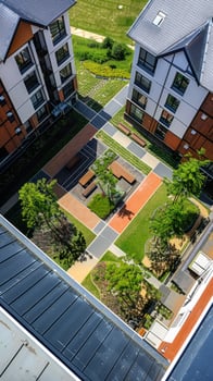 Aerial view of modern residential complex courtyard with green spaces and pathways photo