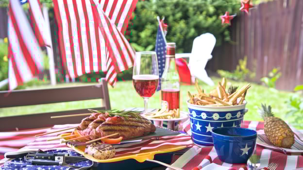 Patriotic Outdoor BBQ with American Flags, Grilled Sausages, and Fries photo