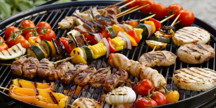 Colorful barbecue skewers and grilled vegetables on a grill photo