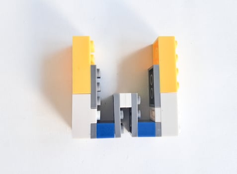 letter made from children toys on white background photo