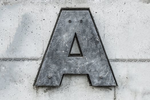 dark gray letter a on concrete background photo