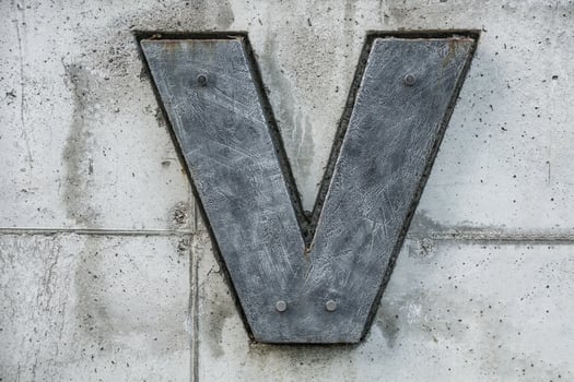 dark gray letter v on concrete background photo
