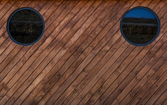 Medium brown wood texture backviewed from above.The wooden planks are stacked diagonally and have a worn look.rn look. photo