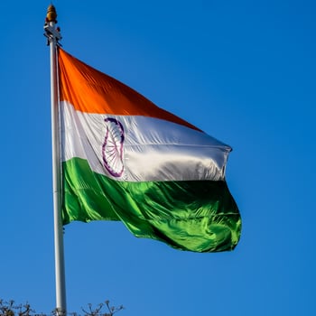 India flag flying high at Connaught Place with pride in blue sky, India flag fluttering, Indian Flag on Independence Day and Republic Day of India, tilt up shot, Waving Indian flag, Har Ghar Tiranga photo
