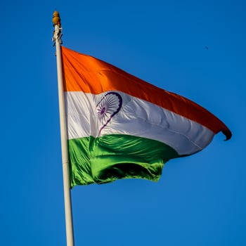 India flag flying high at Connaught Place with pride in blue sky, India flag fluttering, Indian Flag on Independence Day and Republic Day of India, tilt up shot, Waving Indian flag, Har Ghar Tiranga photo