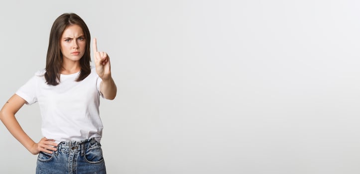 Angry disappointed woman shaking finger in disapproval, scolding person making wrong decision photo