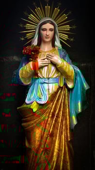Mother Mary sacred peaceful prayer place, blessed Virgin Mary statue, praying Virgin Mary statue. Religious background on church interior background photo