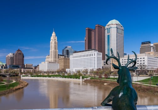 Columbus, OH - 7 April 2024. Deer statue by Terry Allen overlooking the skyline by the river Scioto photo