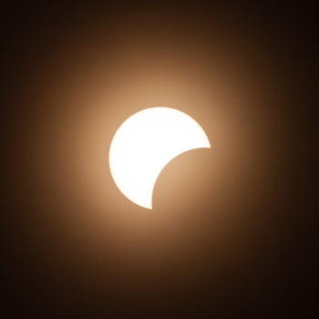 Early stage of the solar eclipse in April 2024 with the moon starting to cover the sun photo