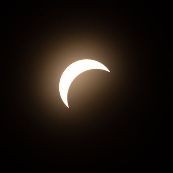 Early stage of the solar eclipse in April 2024 with the moon starting to cover the sun photo