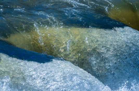 Frozen motion view of raging water flowing over rocks of Valley Falls State Park on Tygart River near Fairmont West Virginia photo
