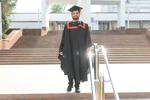 education, graduation and people concept - happy Indian Male graduate student photo