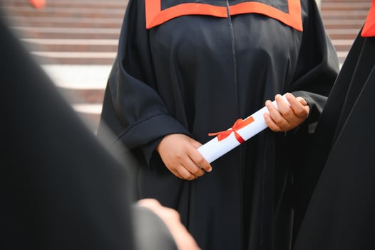 Close up people graduating with diplomas photo